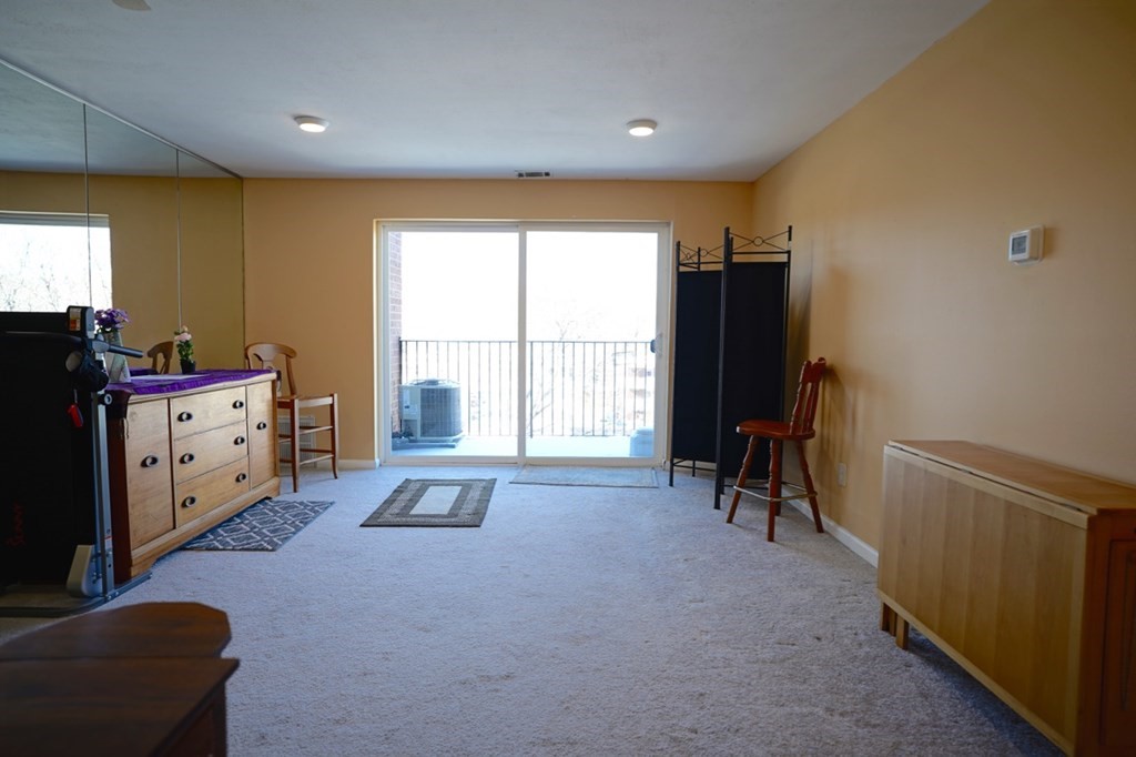 175 Clare Avenue, Unit E8 Boston, MA 02136 - Photo 3 of 25 a room with furniture and a window