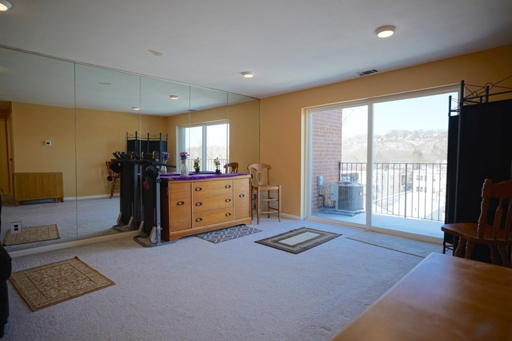 175 Clare Avenue, Unit E8 Boston, MA 02136 - Photo 5 of 25 a living room with a couch and a flat screen tv