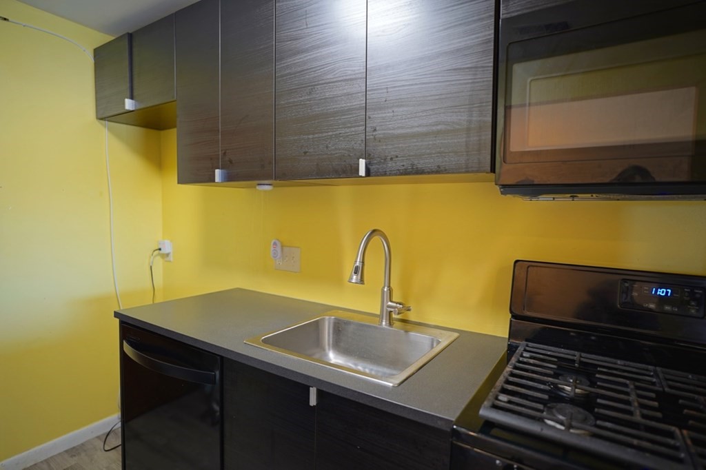 175 Clare Avenue, Unit E8 Boston, MA 02136 - Photo 6 of 25 a bathroom with a sink and a washing machine