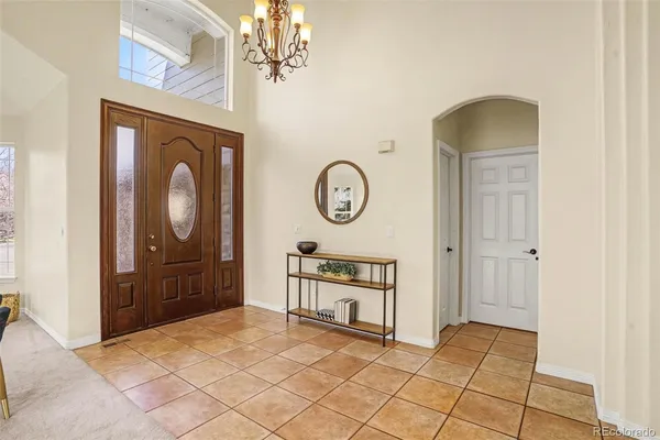 a view of a hallway with entryway wooden floor and front door