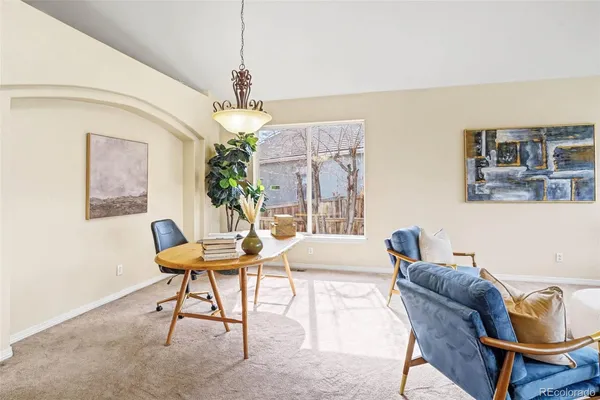 a dining room with furniture and window