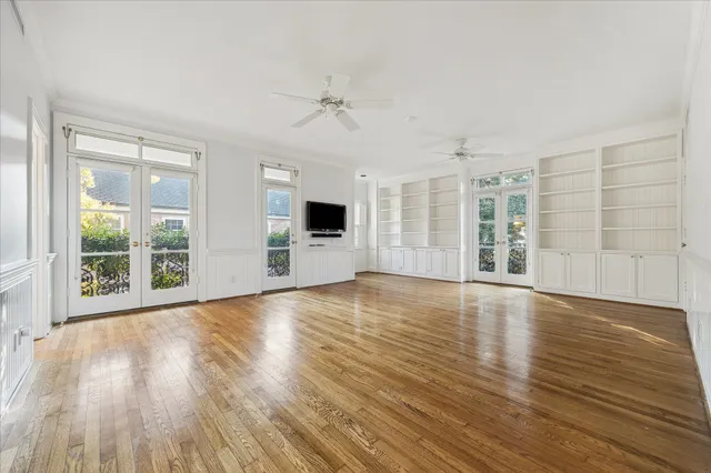 front view of a house with a yard and potted plants