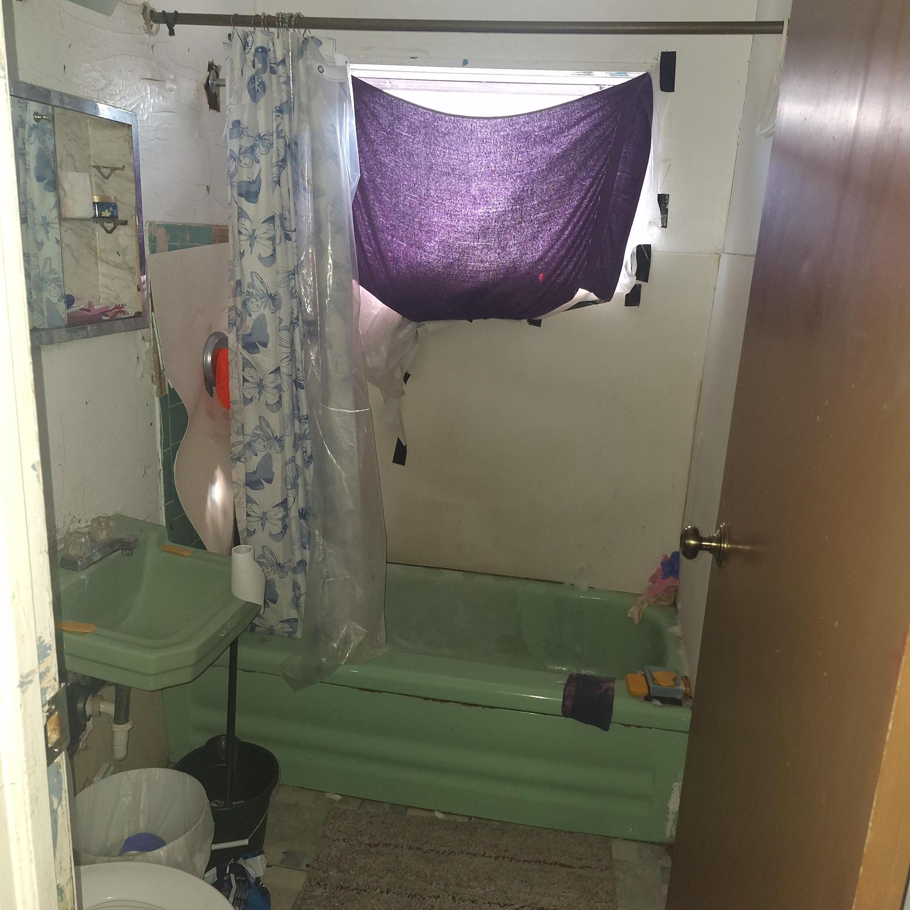 2173 Baker Street Gary, IN 46404 - Photo 6 of 7 a bathroom with a shower and a sink