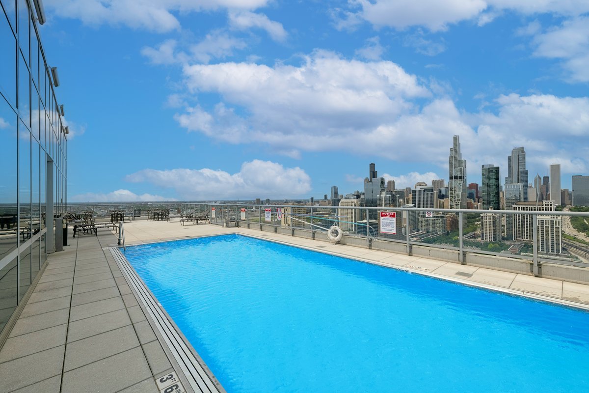 1629 South Prairie Avenue, Unit 801 Chicago, IL 60616 - Photo 25 of 33 a view of a swimming pool with a table and chairs