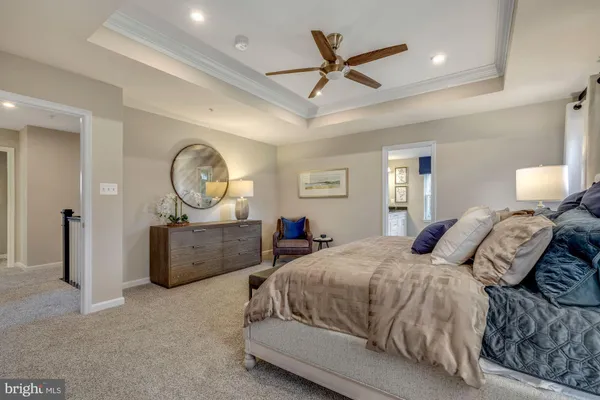 a bed room with a bed mirror and a window