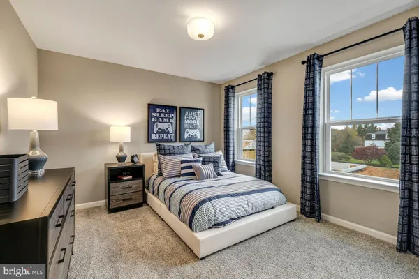a bedroom with a bed and lamp with window