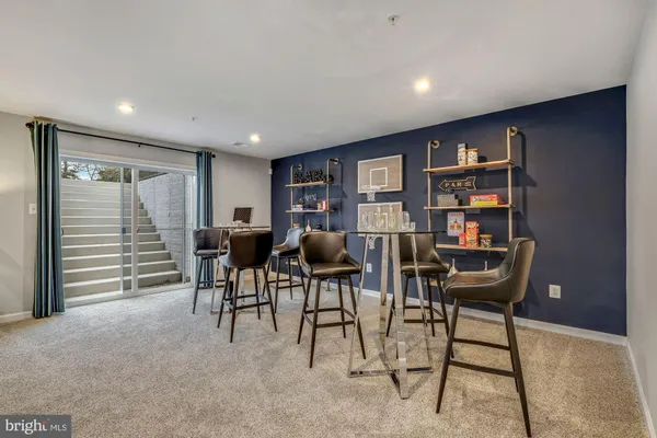 a view of a livingroom with furniture and a bookshelf