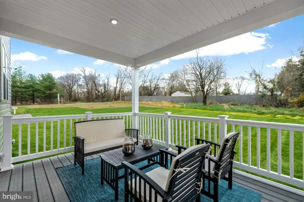 a view of a deck with furniture and wooden floor