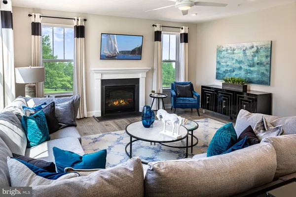 a living room with furniture fireplace and a large window