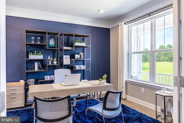 a dining room with furniture window and wooden floor