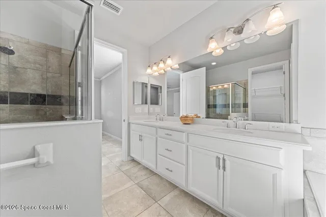 a bathroom with a glass shower door