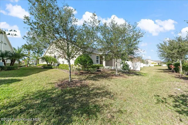 an aerial view of a house with a big yard