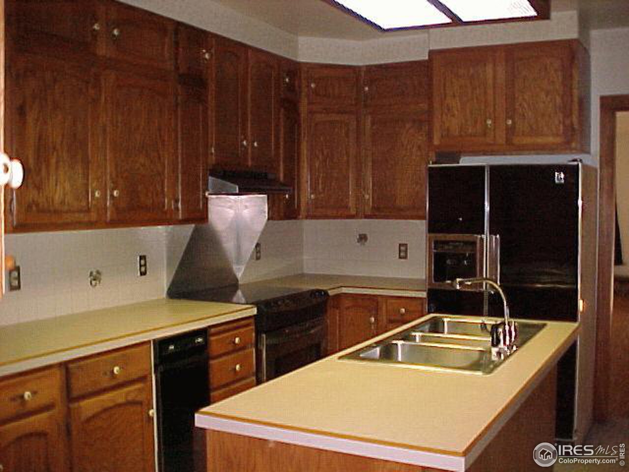 4375 East County Line Road Erie, CO 80516 - Photo 3 of 10 a kitchen that has a sink and a stove in it