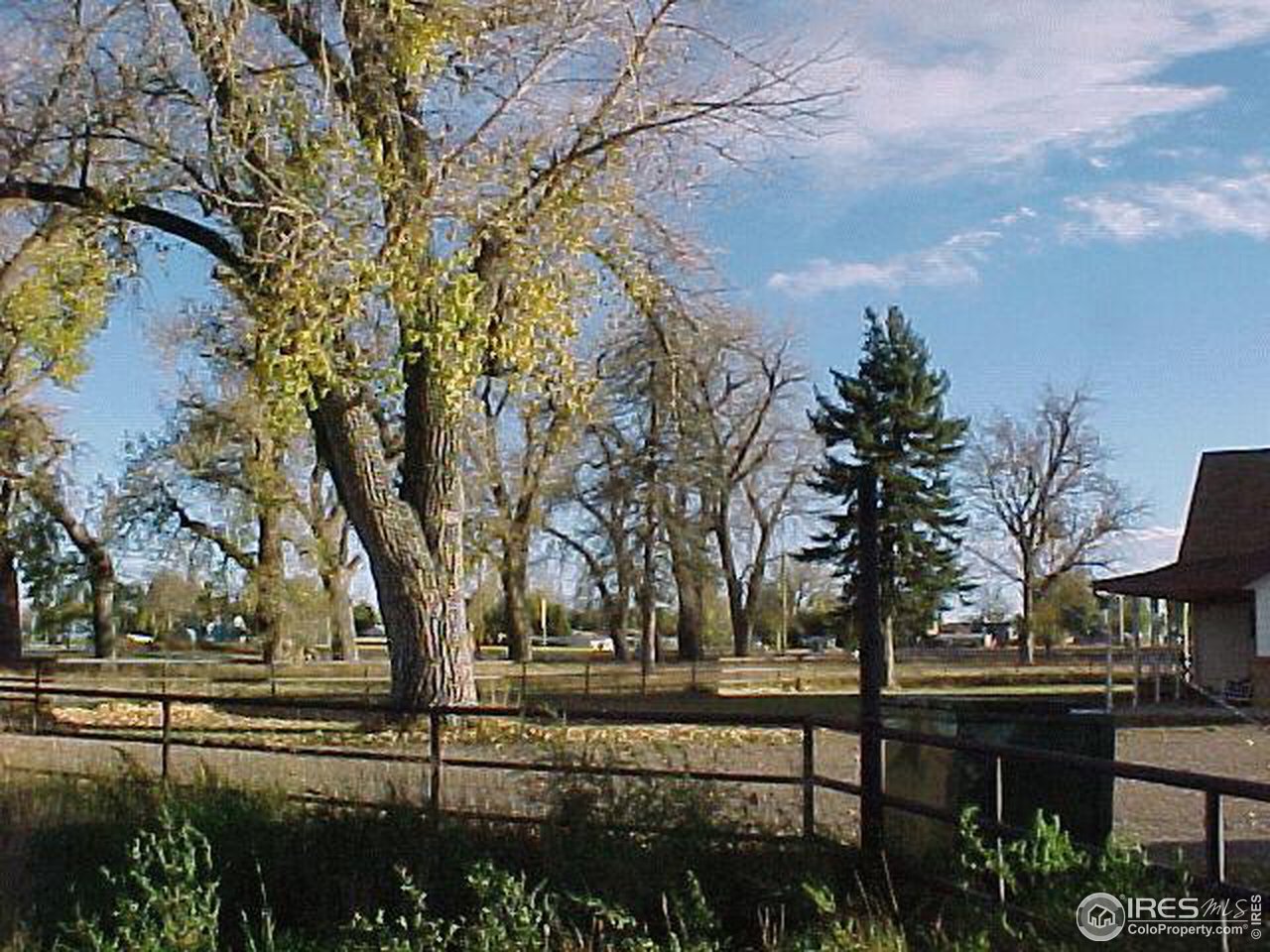 4375 East County Line Road Erie, CO 80516 - Photo 5 of 10 a view of house with outdoor seating and trees