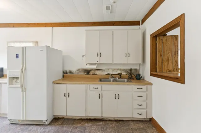 a kitchen with stainless steel appliances a refrigerator and cabinets