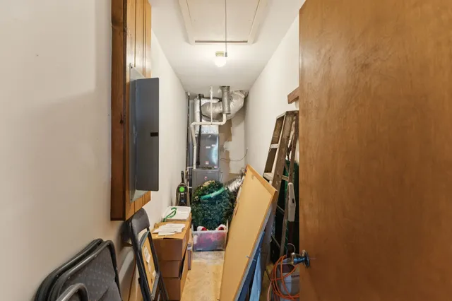 a view of a hallway with furniture and stairs