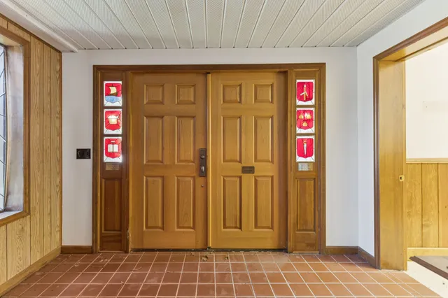 a view of front door with wooden door