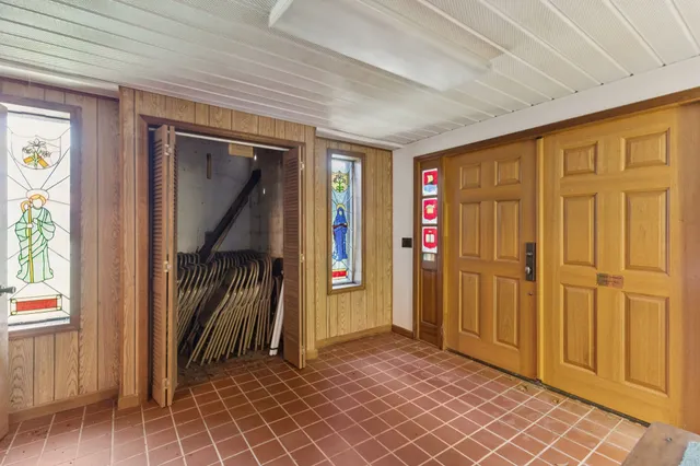 a view of a hallway with wooden walls and entryway