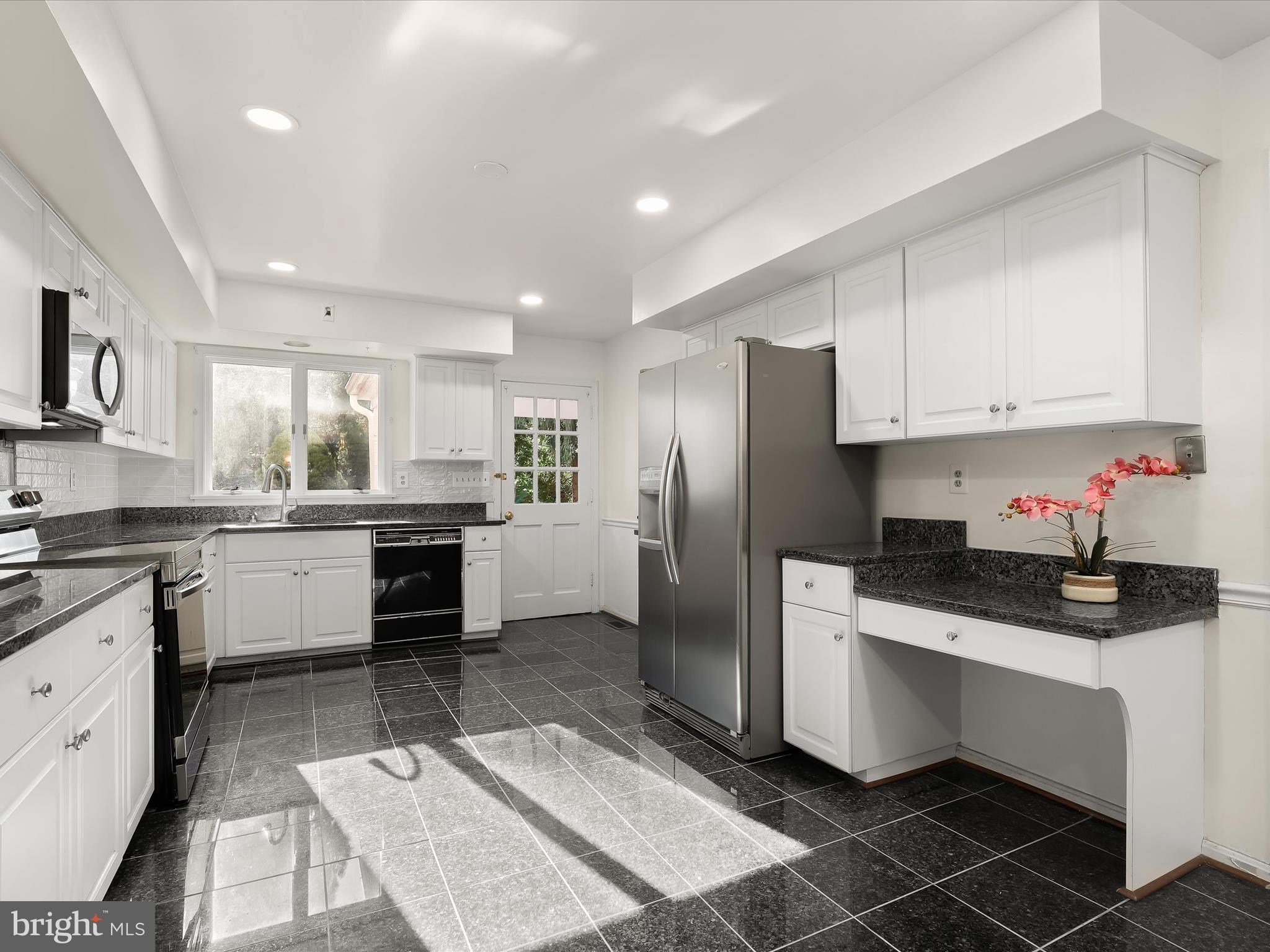 13719 Killarney Court Phoenix, MD 21131 - Photo 14 of 81 a kitchen with granite countertop a refrigerator stove a sink and white cabinets