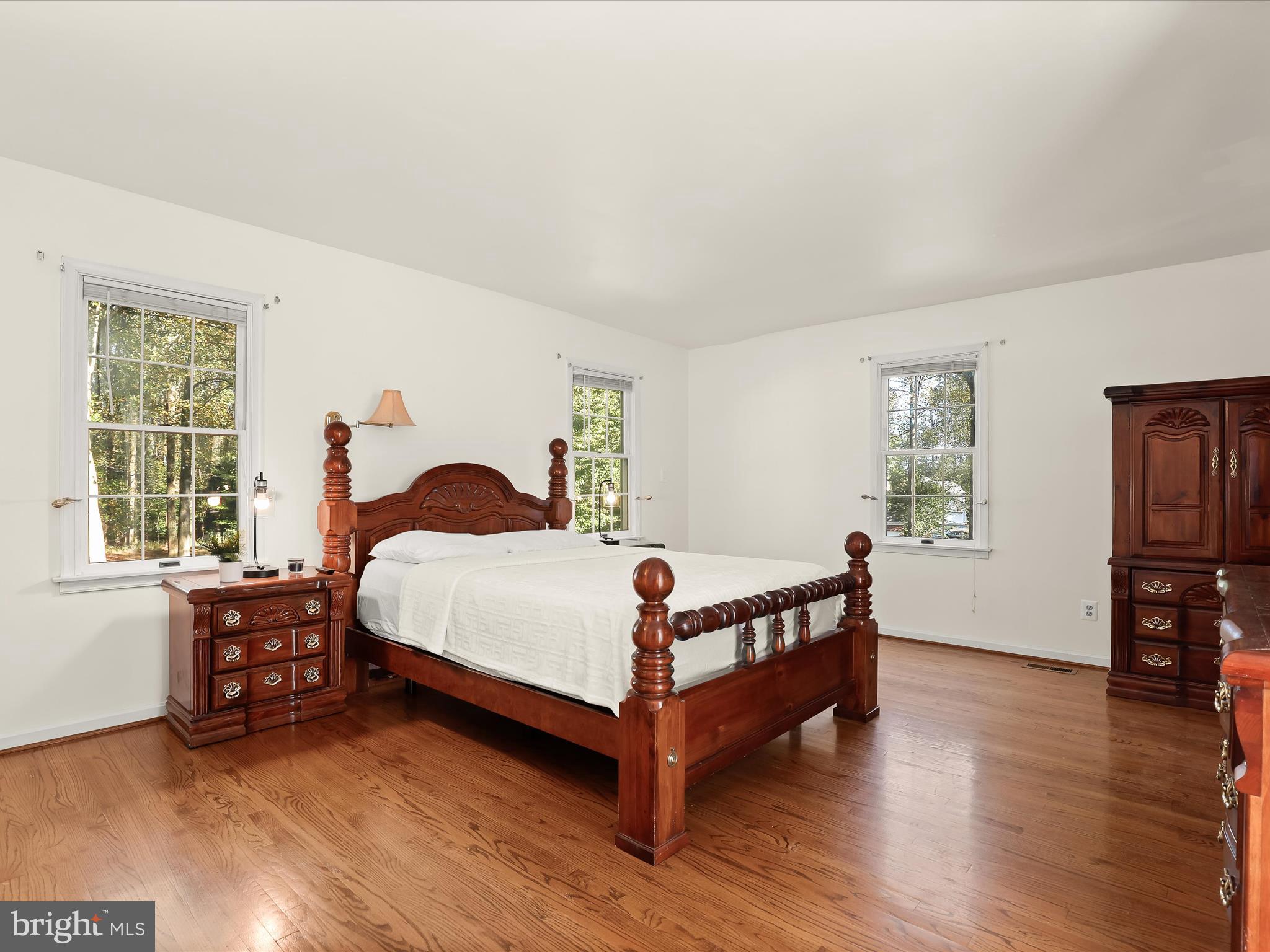 13719 Killarney Court Phoenix, MD 21131 - Photo 30 of 81 a bed sitting in a bedroom next to a window with wooden floor