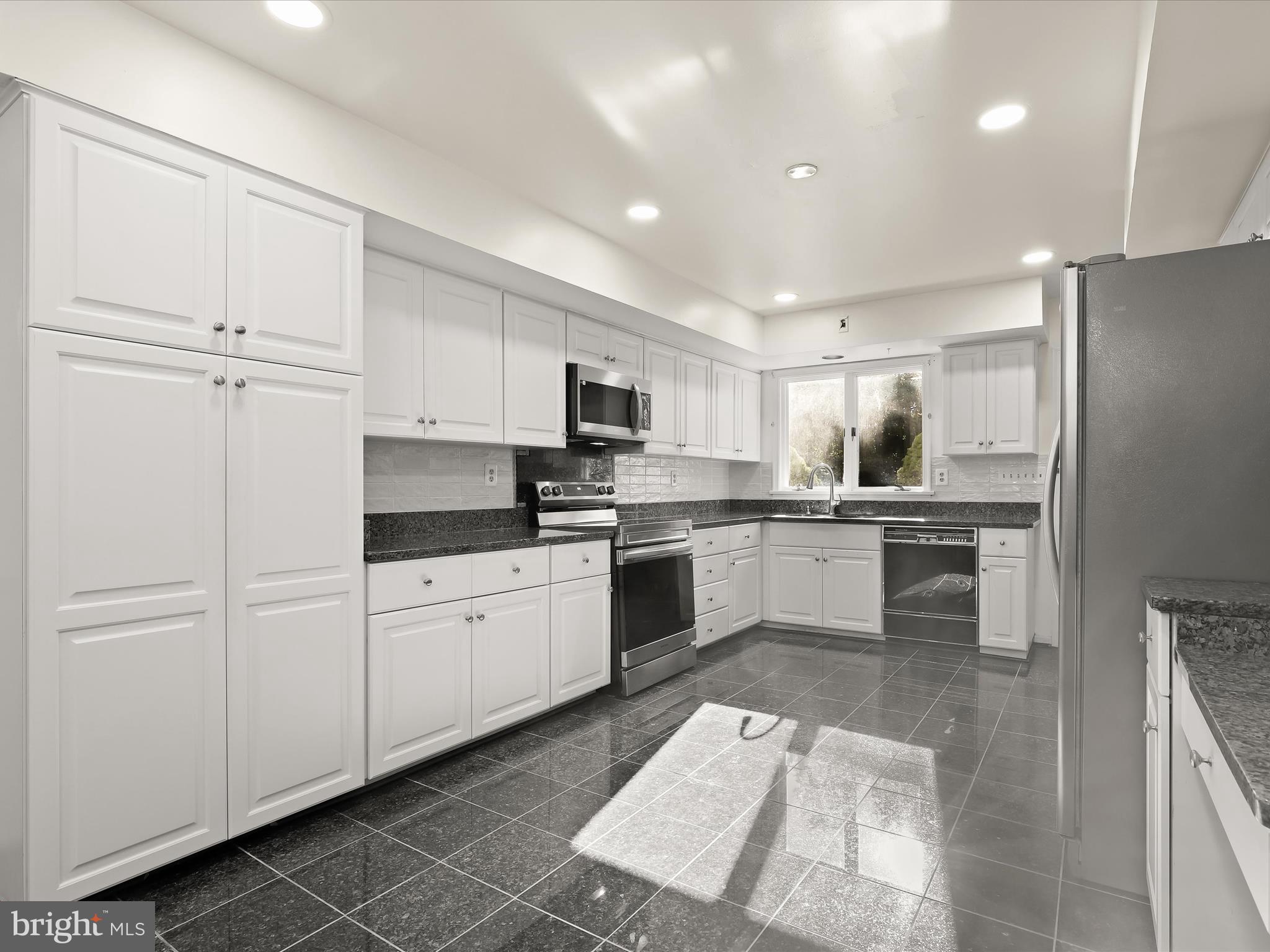 13719 Killarney Court Phoenix, MD 21131 - Photo 5 of 81 a kitchen with white cabinets and appliances