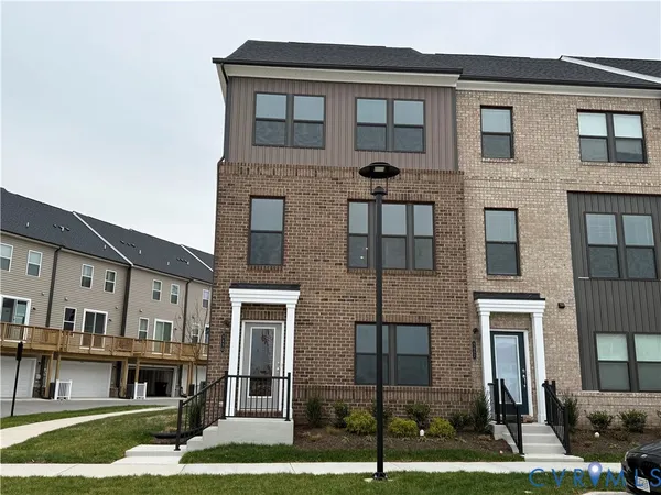 a front view of a residential apartment building with a yard