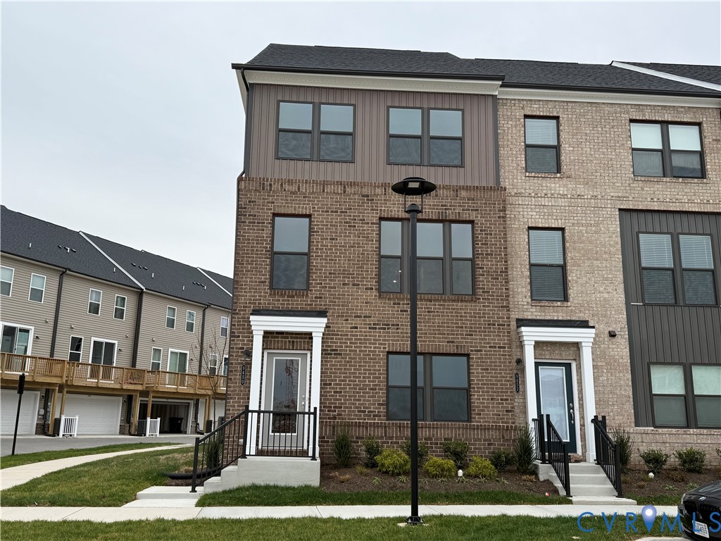 9450 Belladdie Way Glen Allen, VA 23059 - Photo 1 of 23 a front view of a residential apartment building with a yard