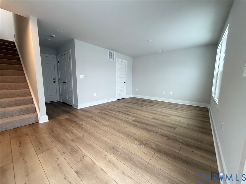9450 Belladdie Way Glen Allen, VA 23059 - Photo 19 of 23 an empty room with wooden floor and entryway