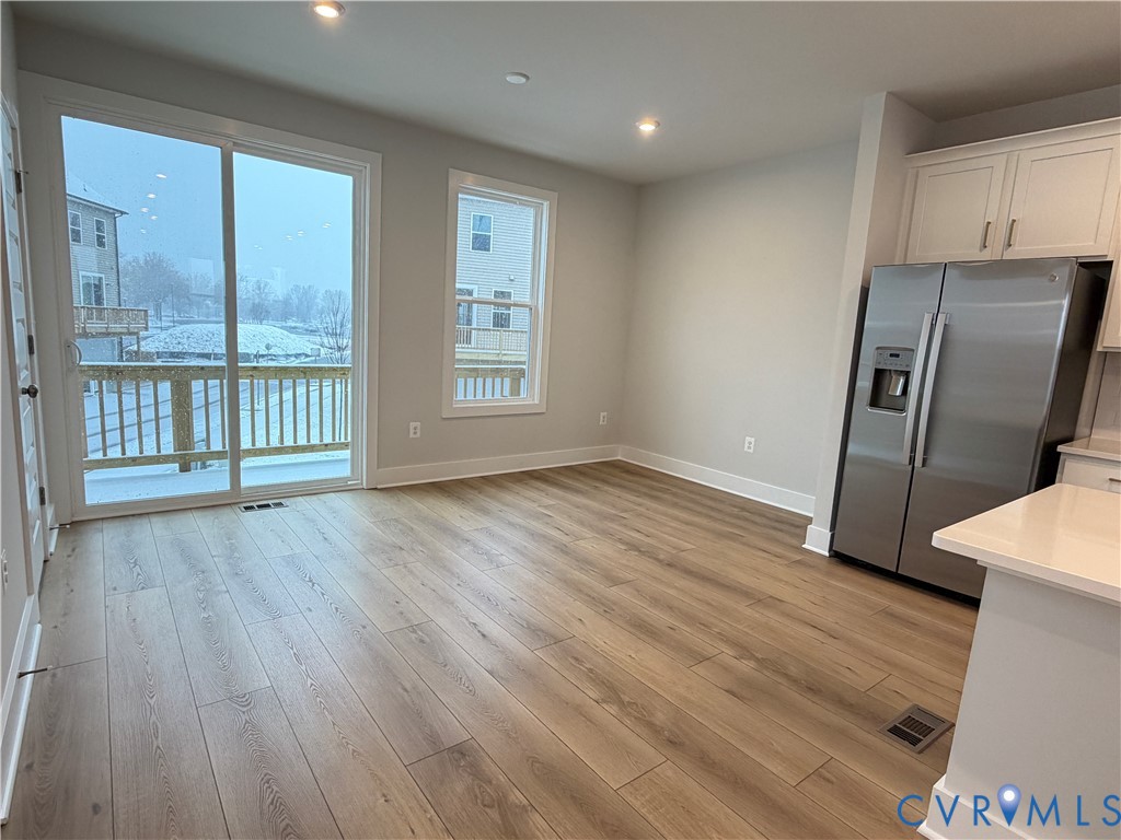 9450 Belladdie Way Glen Allen, VA 23059 - Photo 9 of 23 a view of an empty room with wooden floor and a window