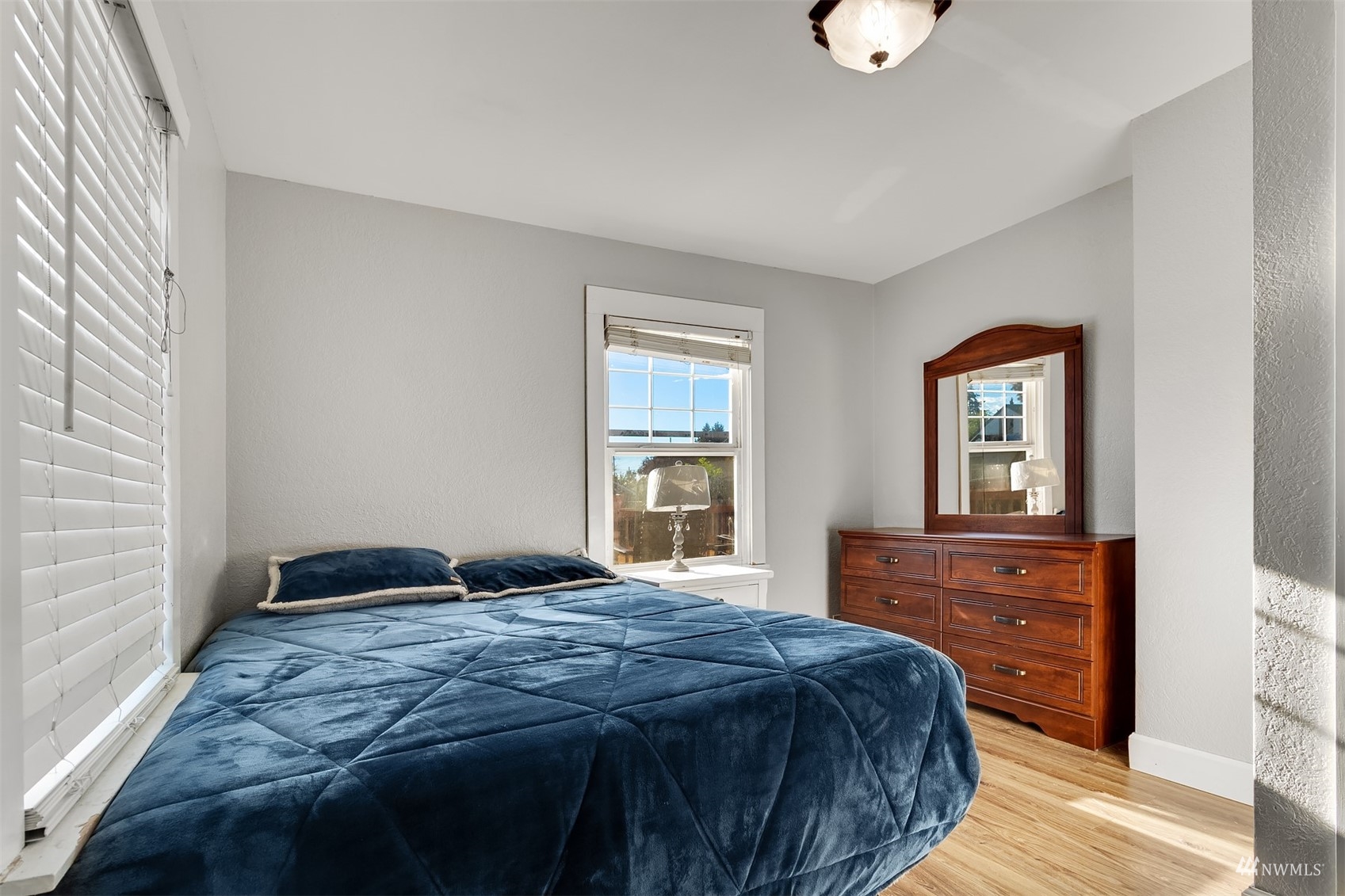 7236 South Montgomery Street Tacoma, WA 98409 - Photo 13 of 34 a bedroom with a bed and wooden floor