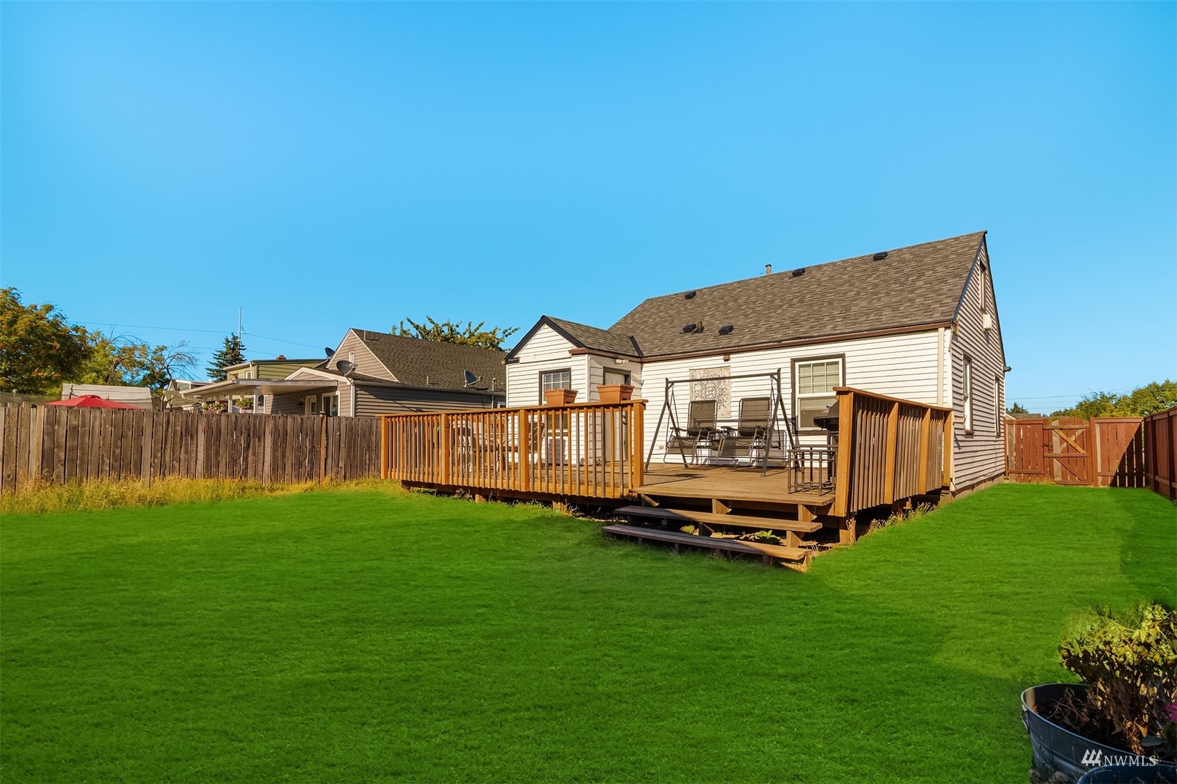 7236 South Montgomery Street Tacoma, WA 98409 - Photo 25 of 34 a view of a house with a big yard and a large trees with wooden fence