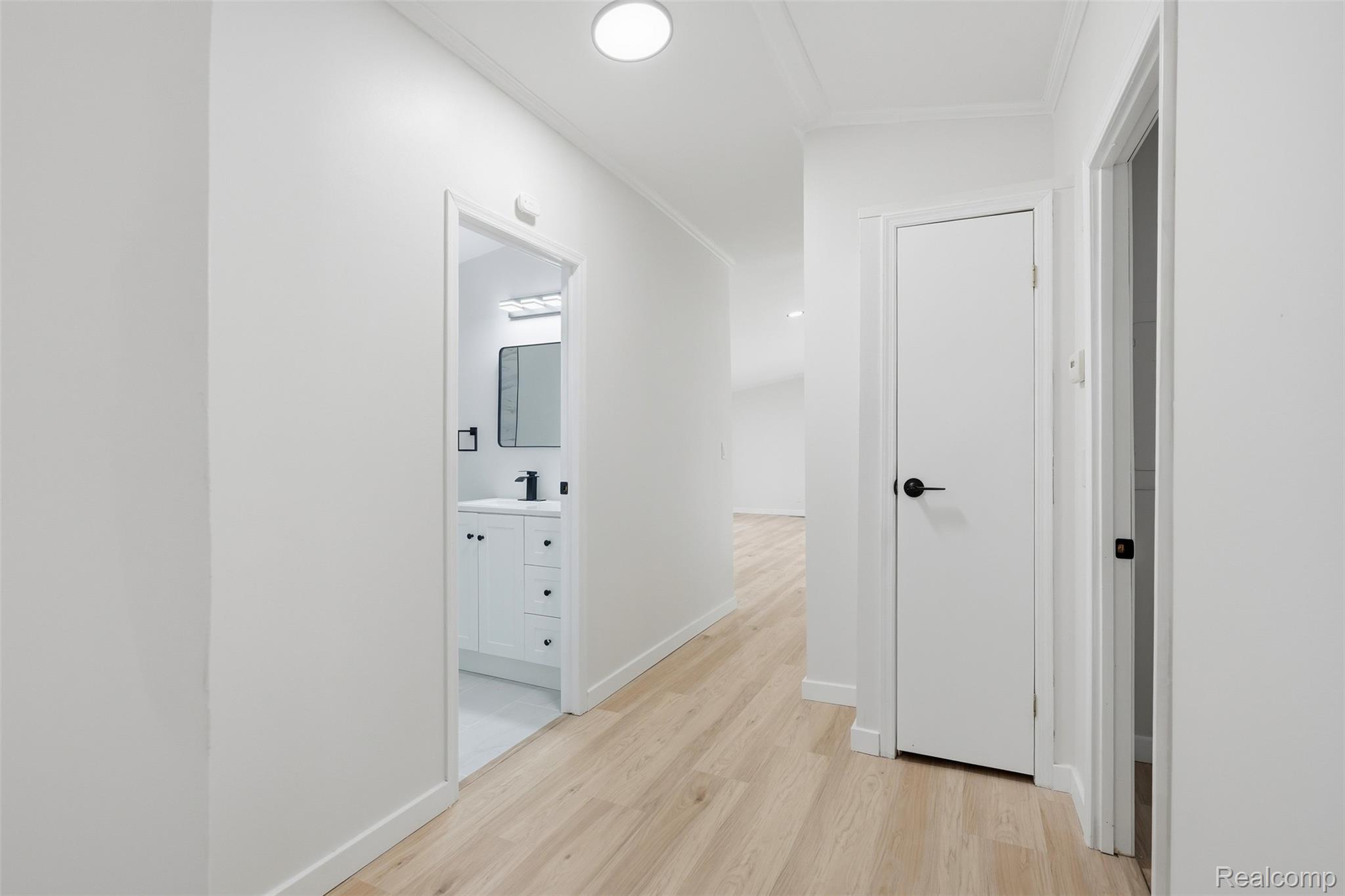 4420 Dublin Road Burton, MI 48529 - Photo 28 of 56 Hallway featuring light wood-finish flooring, recessed ceiling lighting, and white walls