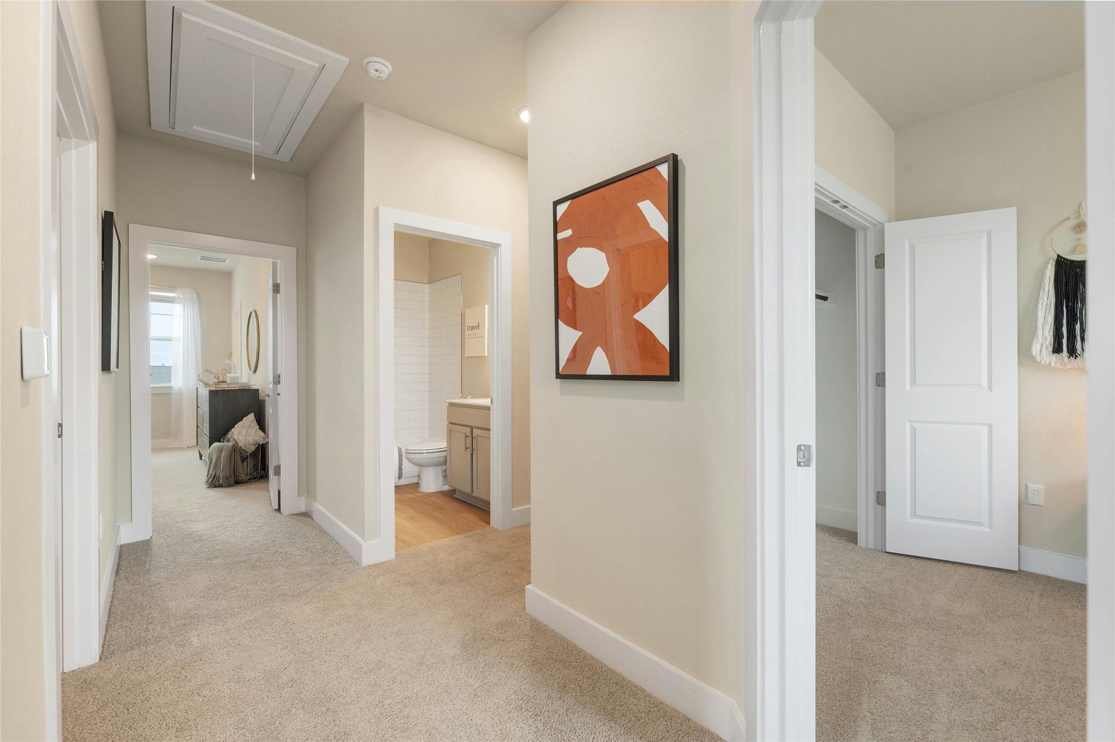 5804 Rotunda View Austin, TX 78747 - Photo 20 of 27 A well-lit hallway connects various rooms, featuring clean carpet and recessed lighting.