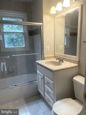 a bathroom with a sink a toilet and bathtub