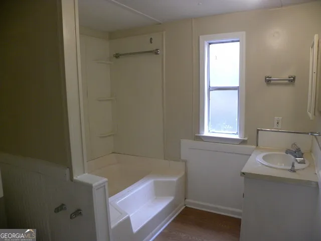 a bathroom with a bathtub and a sink