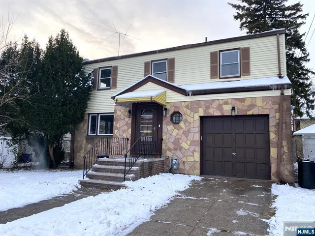 a front view of a house with a garage