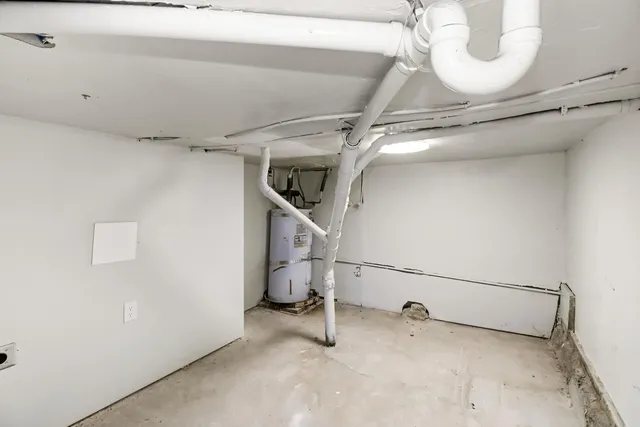 a view of a house with a small yard and wooden floor and fence