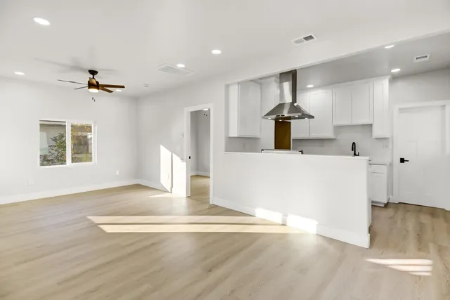 a kitchen with stainless steel appliances a sink stove and refrigerator