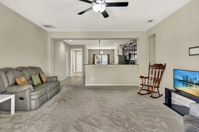 a living room with furniture and a dining area