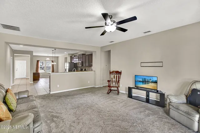 a living room with furniture and white walls