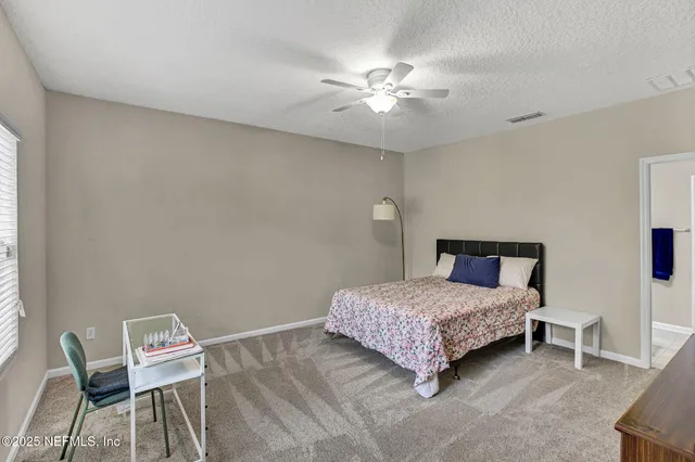 a bedroom with a bed and a chair