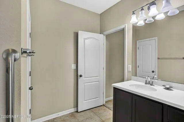 a bathroom with a double vanity sink and mirror