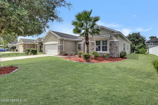 a front view of house with yard and green space