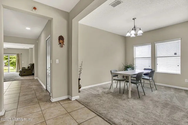 a view of a dining room with furniture and window