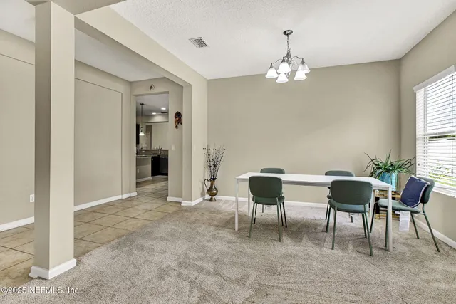 a view of a livingroom with furniture and chandelier