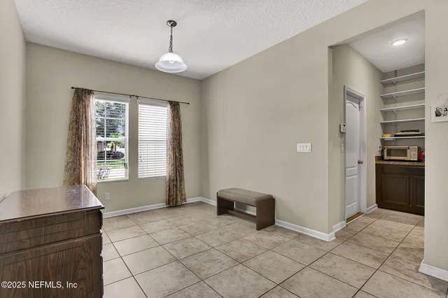 a view of kitchen with windows and refrigerator