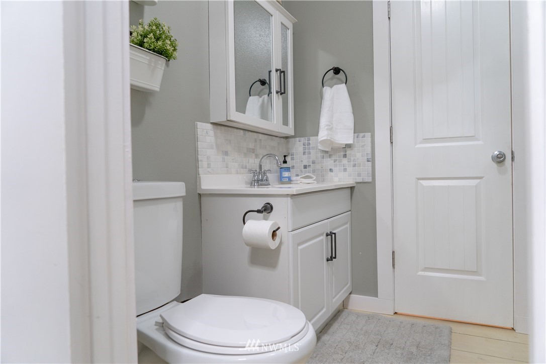 191 Stevens Road Doty, WA 98539 - Photo 12 of 19 a bathroom with a granite countertop sink a toilet and a mirror