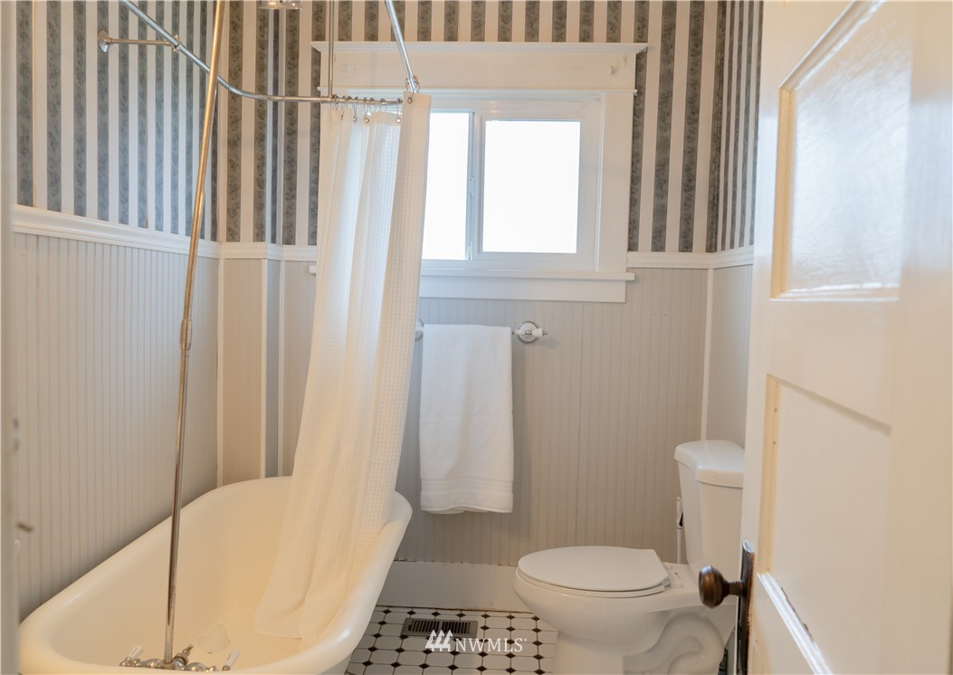 191 Stevens Road Doty, WA 98539 - Photo 14 of 19 a bathroom with a toilet and a shower curtain