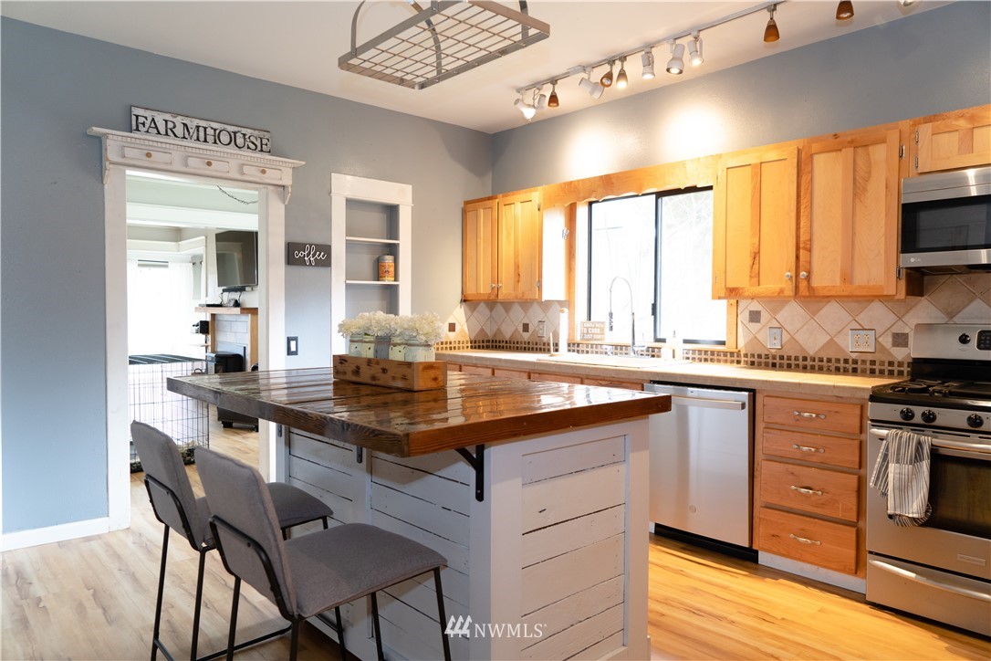 191 Stevens Road Doty, WA 98539 - Photo 10 of 19 a kitchen with a stove a sink a dining table and chairs