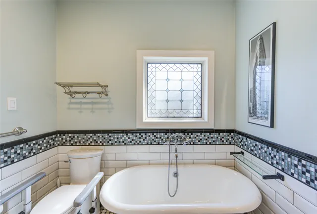 a bathroom with a bathtub and a toilet